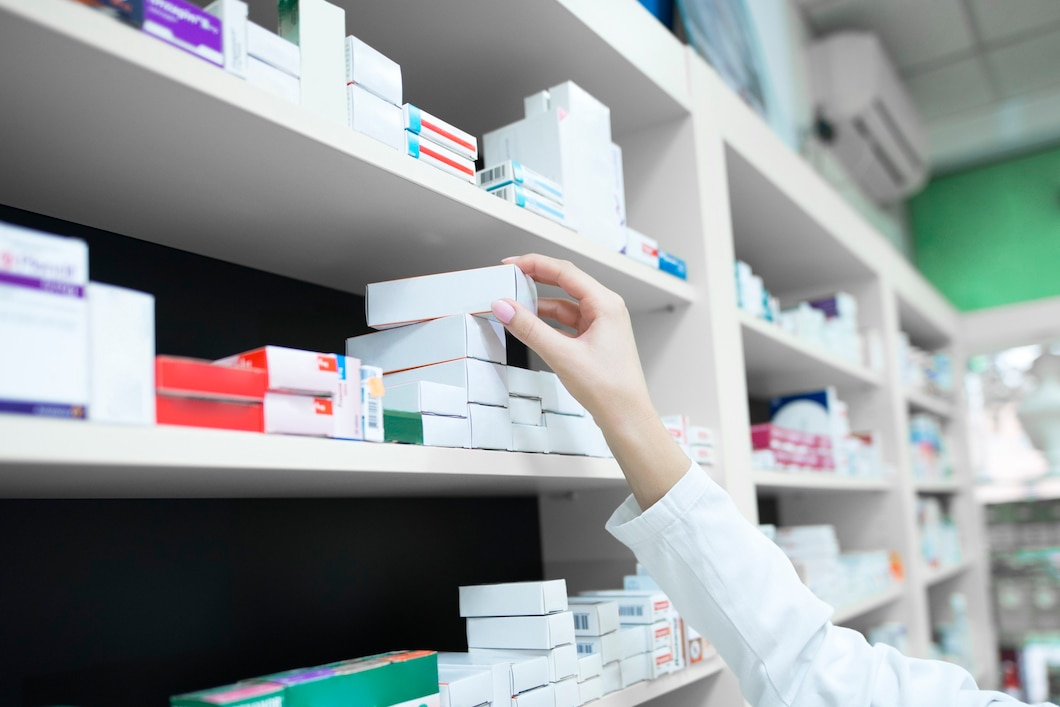 closeup view pharmacist hand taking medicine box from shelf drug store 342744 320