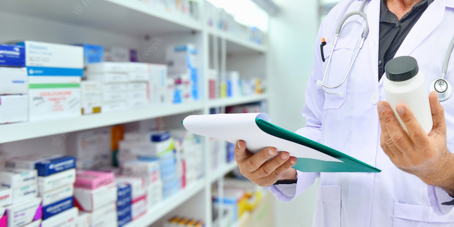 pharmacist holding medicine bottle computer tablet filling prescription pharmacy drugstore 67340 475